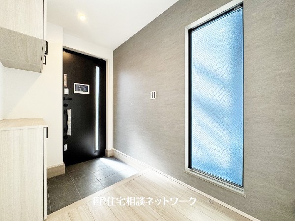 玄関ホールには大きな窓があり、自然光が射し込み、住まう人、訪れる人を心地よく迎え入れてくれる。玄関収納には、ディスプレイスペースがあり、お花、グリーンなどを飾れる。