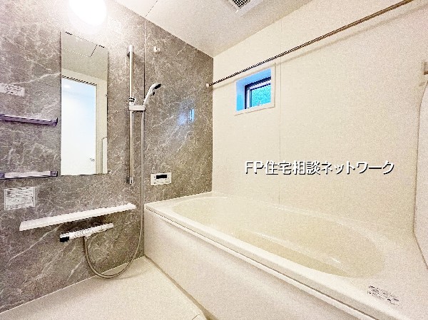 ゆったり浸かれるオーバル型浴槽が魅力のバスルーム。高級感ある石目調パネル＆浴室乾燥機付きで、雨の日の洗濯やカビ対策にも対応。小窓付きで換気性も良く、毎日のバスタイムが心地よく過ごせます。 