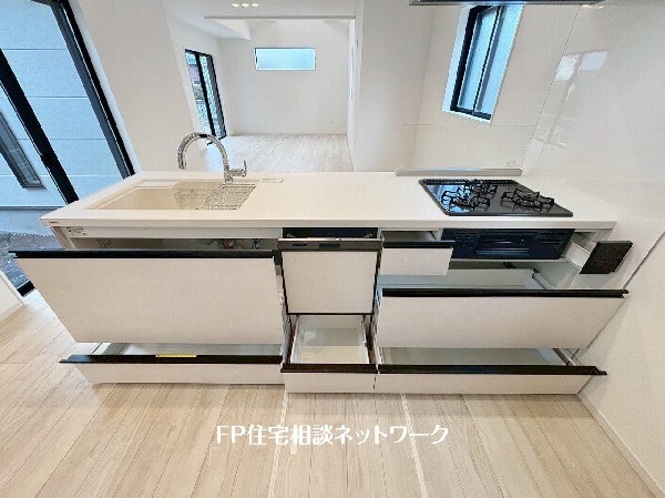 スライド収納付きのシステムキッチン。料理器具なども収納できて出し入れもスムーズ。収納量もたっぷりなので料理器具やストック調味料なども入れられる。