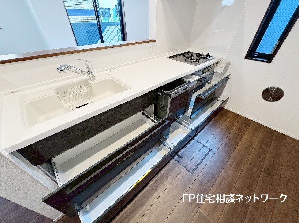 スライド収納付きのシステムキッチン。料理器具なども収納できて出し入れもスムーズ。収納量もたっぷりなので料理器具やストック調味料なども入れられる。