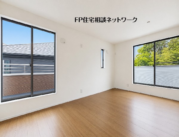 【洋室│5.6帖+4.3帖】２面の窓から光が差し込む洋室です。木目調フローリングと白い壁紙を基調としています。窓からは緑やバルコニーが見え、採光や通風が良好なシンプルな空間です。