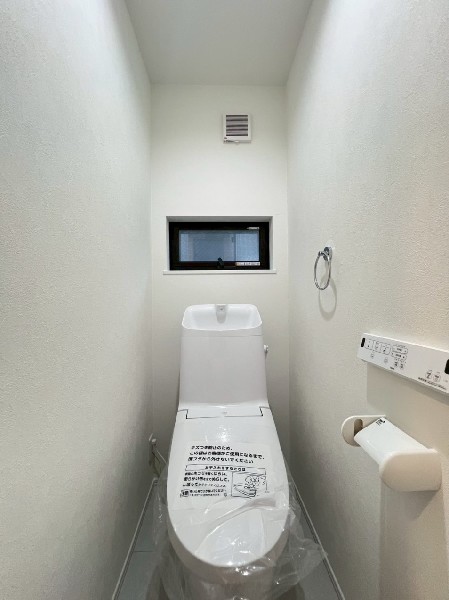 窓があるので陽ざしが入り明るいトイレ。洗浄機能付き便座を標準装備しています。1階と2階にあります。